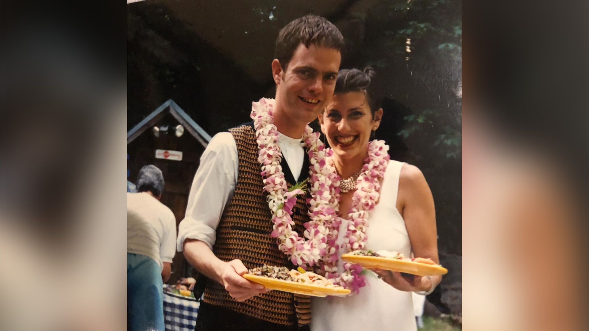 Il giovane Rainn Wilson e Holiday Reinhorn con ghirlande di fiori rosa al collo