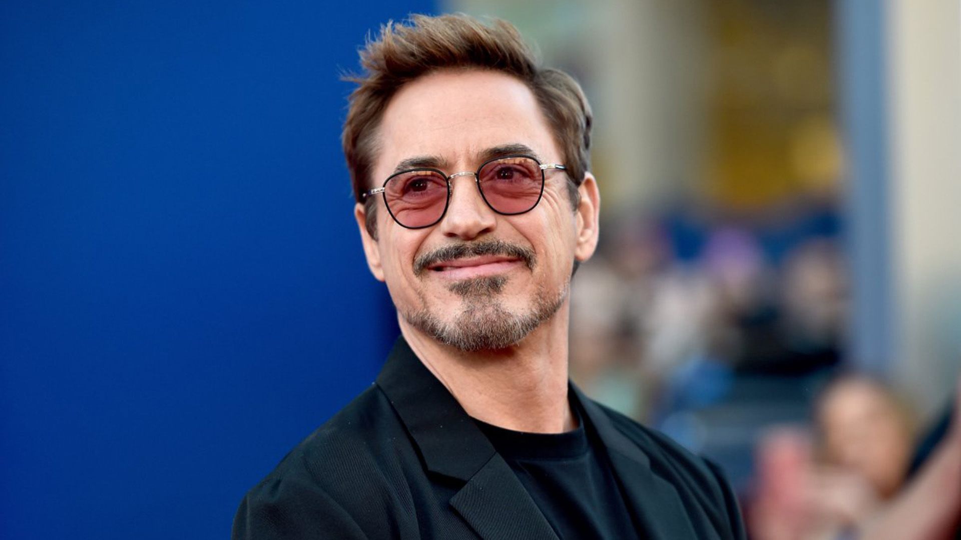 Smiling actor Robert Downey Jr. in purple glasses