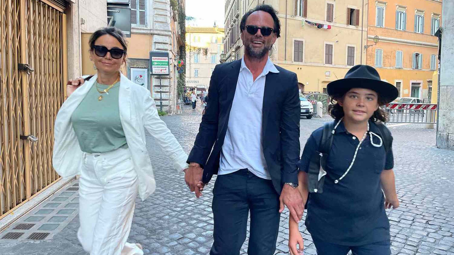 Walton Goggins, sua moglie Nadia Conners e il loro figlio Augustus stanno camminando per strada sorridendo