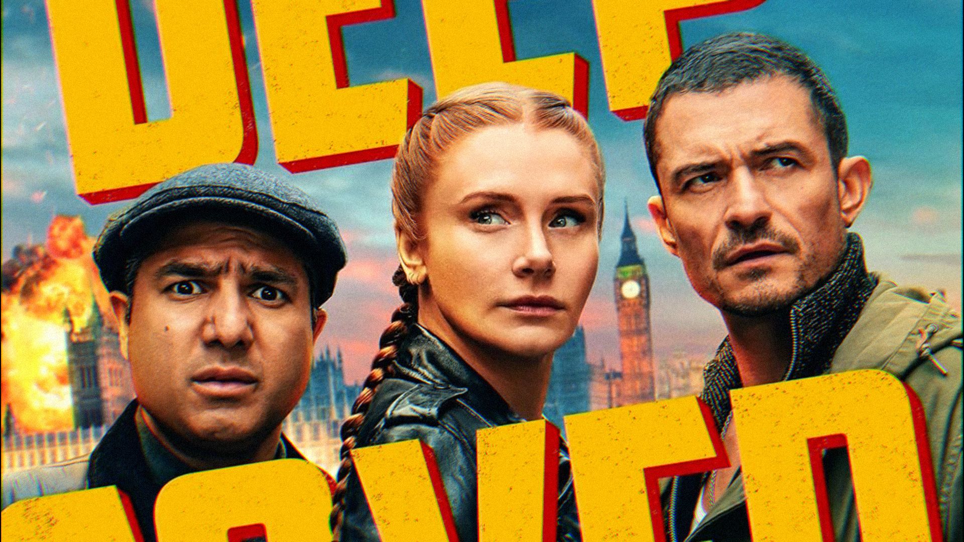 Gli attori Bryce Dallas Howard, Orlando Bloom e Nick Mohammed guardano in direzioni diverse con facce serie
