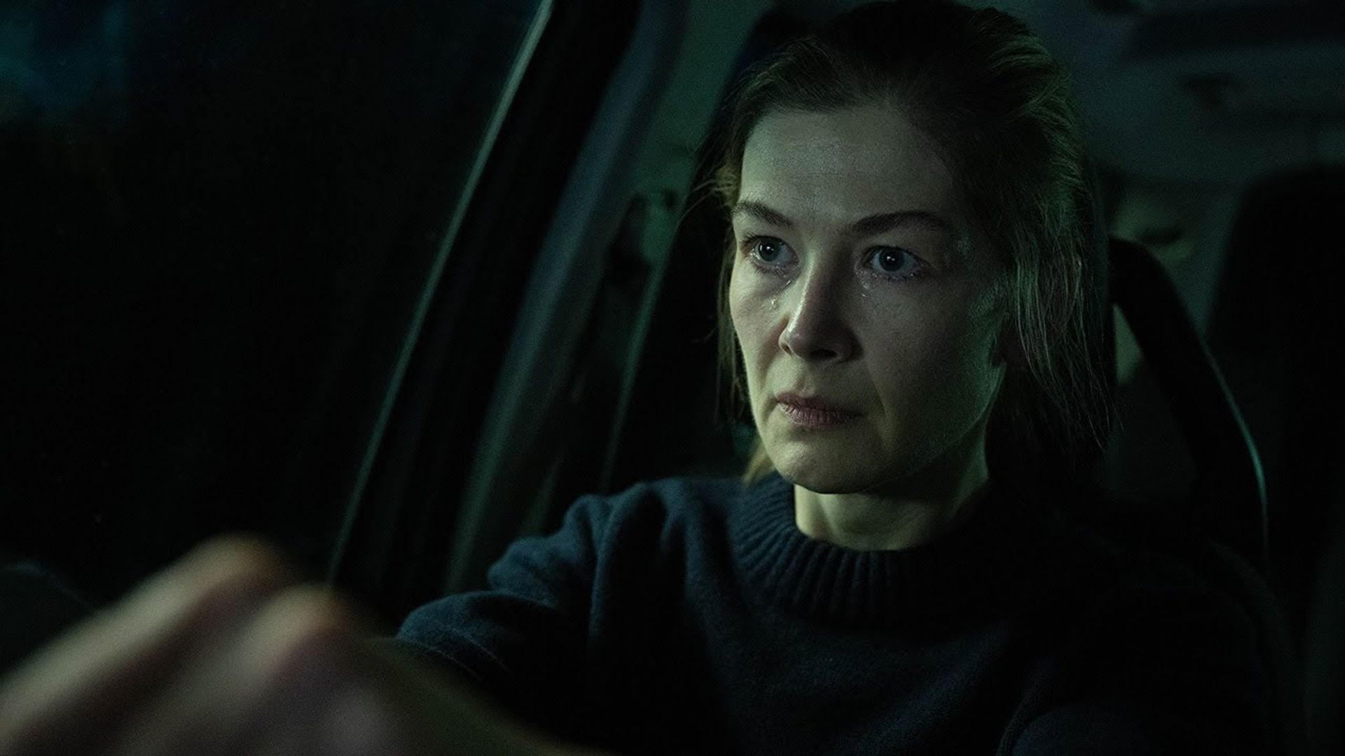 Telefono su supporto, l'attrice Rosamund Pike seduta al volante di un'auto