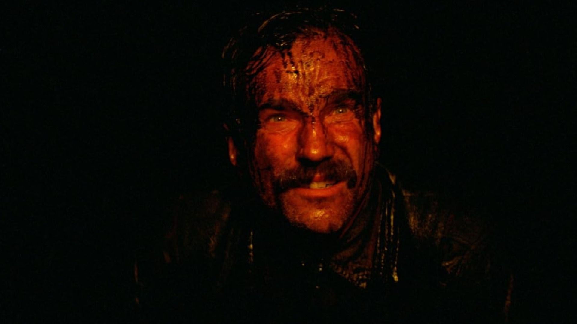 L'attore Daniel Day-Lewis sorride con gocce di petrolio sul viso