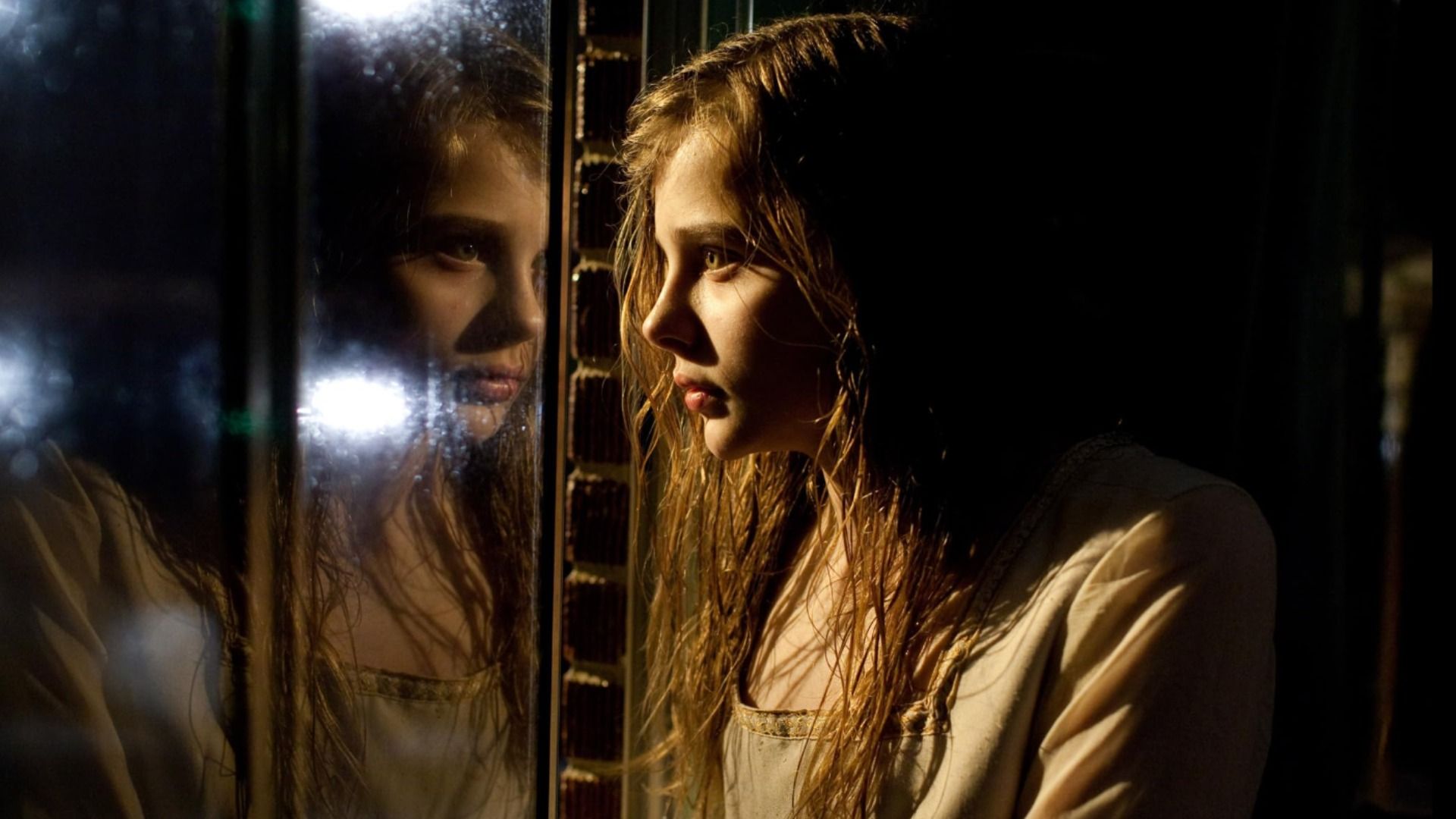 L'attrice Chloë Grace Moretz guarda il suo riflesso nella finestra